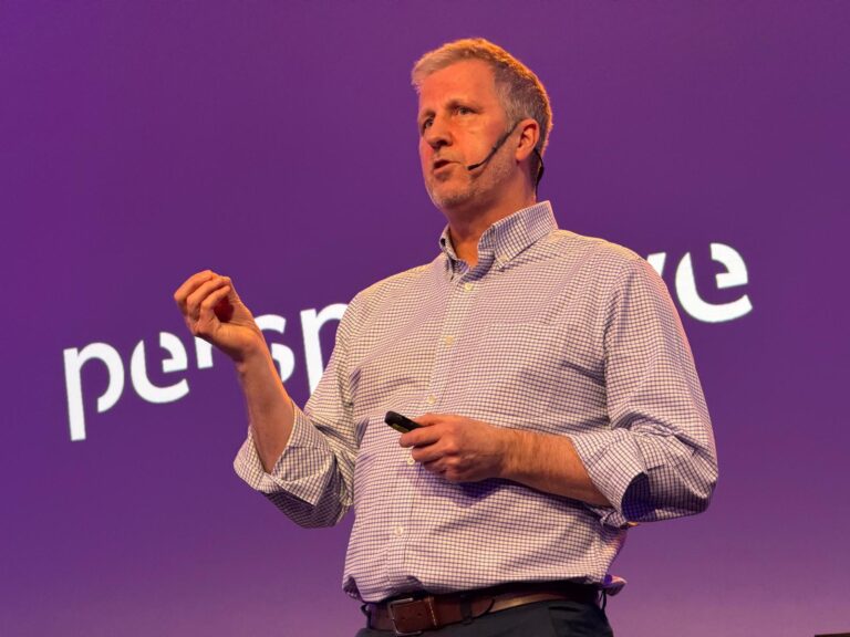 Ross standing in front of a screen that says simply "perspective"