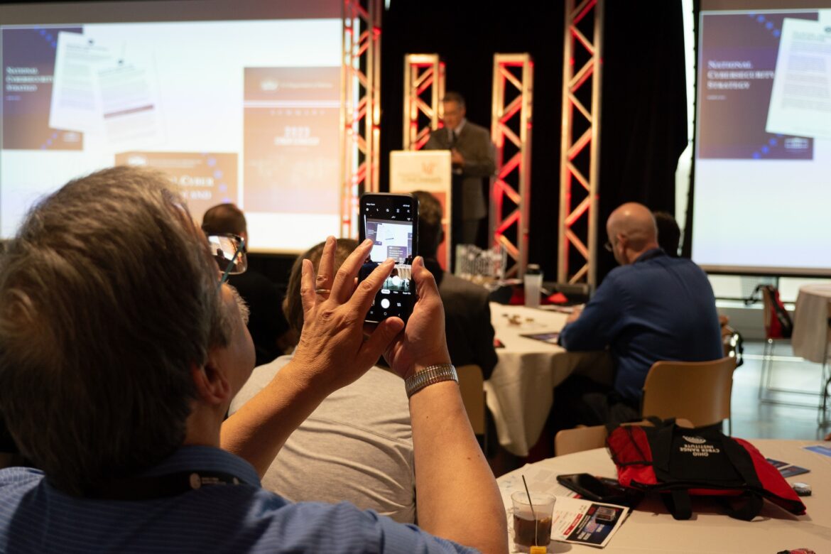 audience member photographing a presentation